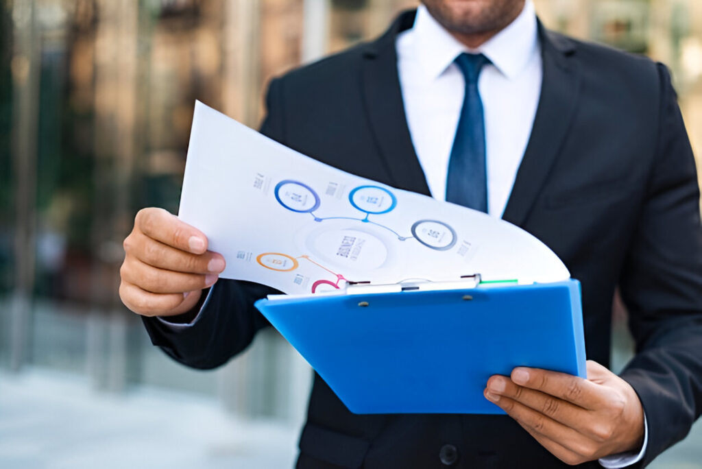 Businessman reviewing financial charts on clipboard