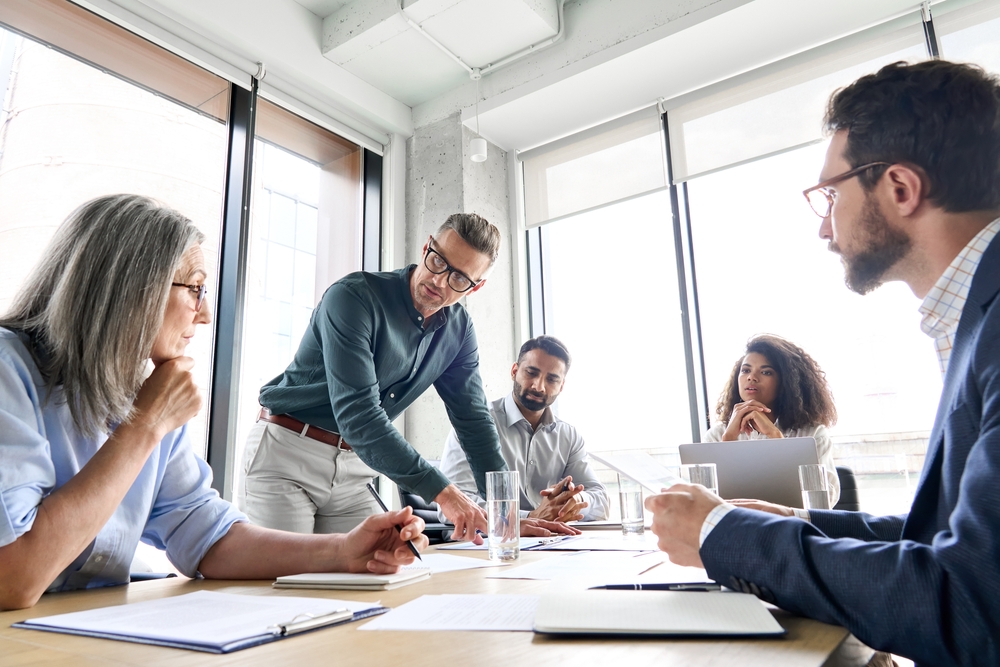 Team collaboration in modern office meeting room.