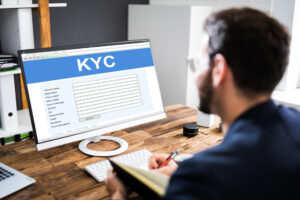 Man completing KYC form on computer