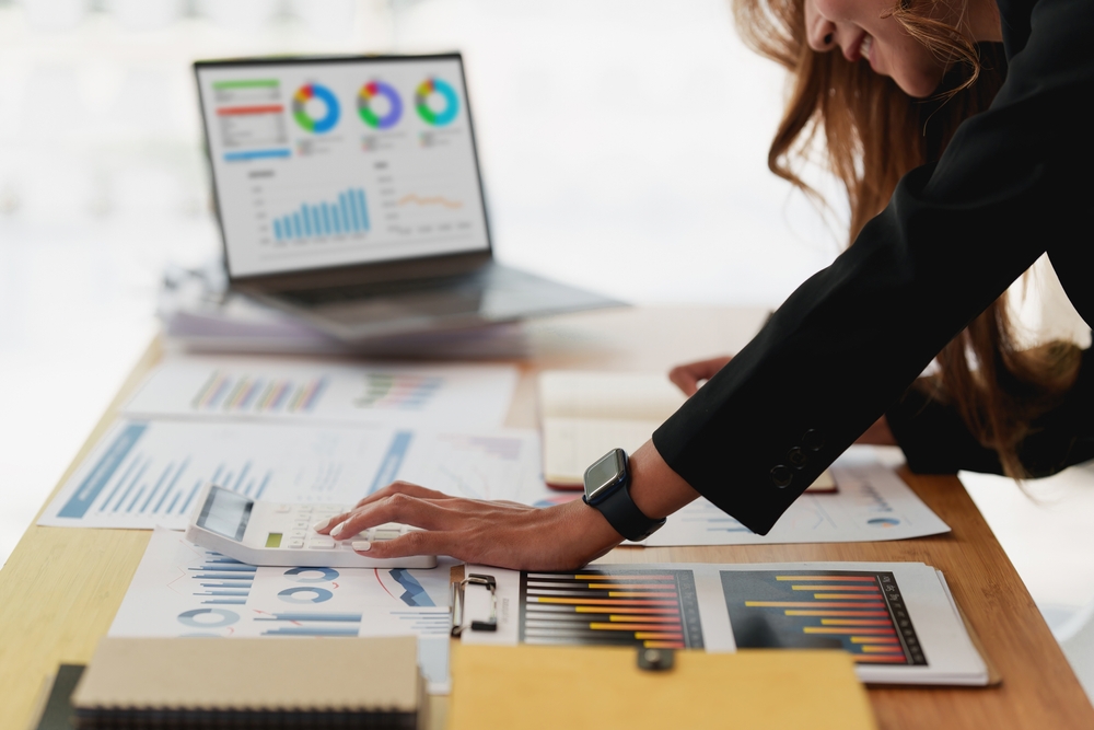 Businesswoman analyzing financial charts and graphs